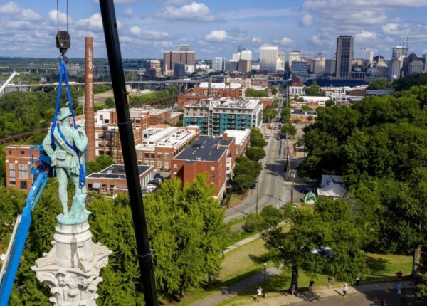 Crews work to remove the Confederate Soldiers & Sailors Monument in Libby Hill Park on July 8 in Richmond, Va. The statue is one of several that will be removed by the city as part of the Black Lives Matter reaction. Survivors of police brutality in Chicago are waiting for a memorial city officials approved five years ago. (AP Photo/Steve Helber)