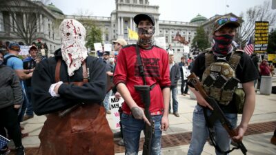 Protesters and militia gathered outside the Capitol in Harrisburg this April for a reopen protest. A recent report by a worldwide nonprofit that tracks militia groups said Pennsylvania is one of five U.S. states at high risk of violence through Nov. 3. (DAVID MAIALETTI / Philadelphia Inquirer)