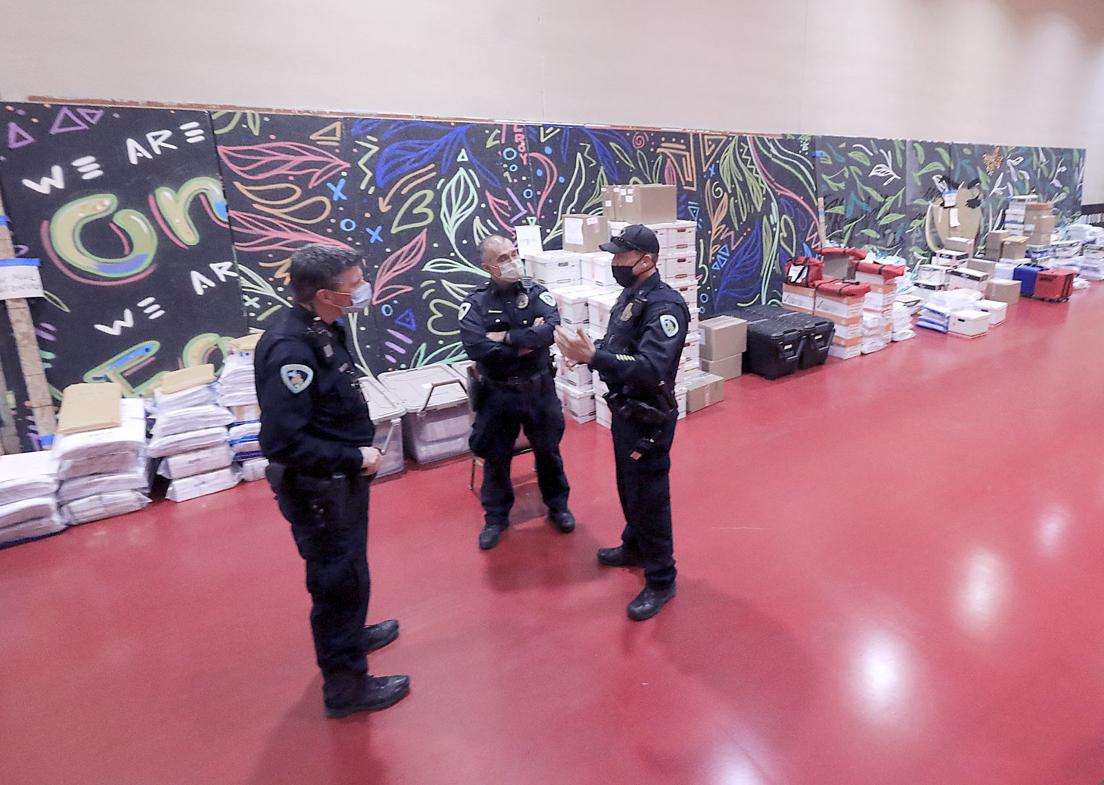 Madison Police Department officers are stationed adjacent to boxes of ballots cast by Dane County, Wis. voters in the 2020 presidential election during a recount of the votes at the Monona Terrace convention center in Madison, Wis. Friday, Nov. 20, 2020. (John Hart/Wisconsin State Journal via AP)
