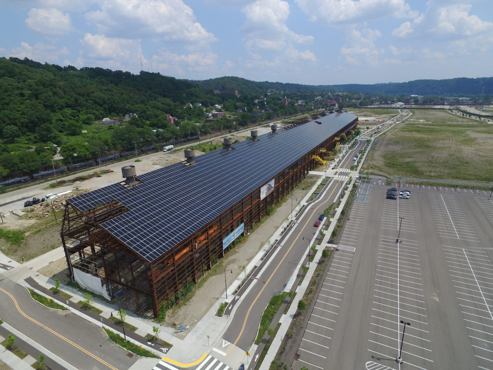 Mill 19, with its residential-style sloping ceiling instead of the flat ceiling more common on commercial buildings, is said to be the largest single-slope solar installation in the country. The former mill located along the Monongahela River in Pittsburgh now houses companies including Carnegie Mellon’s Advanced Robotics for Manufacturing. The nonprofit Regional Industrial Development Corporation operates Mill 19.(photograph provided by RIDC)