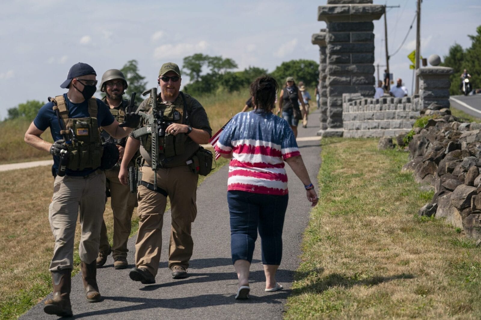 Members of a militia walk past a tourist as they patrol the area surrounding the Gettysburg National Cemetery on July 4, 2020, at Gettysburg National Military Park in Pennsylvania. (AP Photo/Carolyn Kaster) Self-described militia members flocked to Gettysburg amid rumors of an "antifada" flag burning — which the Washington Post later revealed as a hoax perpetrated by a man living in a small town north of Pittsburgh.
