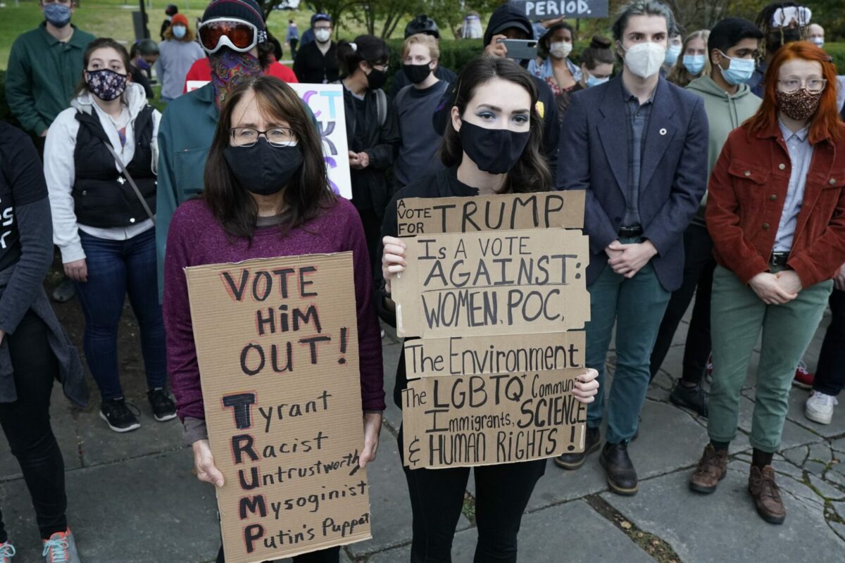 Protesters listen to speakers at a rally near the debate hall, Tuesday, Sept. 29, 2020, in Cleveland. The first presidential debate between Republican candidate President Donald Trump and Democratic candidate and former Vice President Joe Biden is being held in Cleveland on Tuesday. (AP Photo/Tony Dejak)