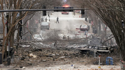 Emergency personnel work near the scene of an explosion in downtown Nashville, Tenn., Friday, Dec. 25, 2020. Buildings shook in the immediate area and beyond after a loud boom was heard early Christmas morning.(AP Photo/Mark Humphrey)