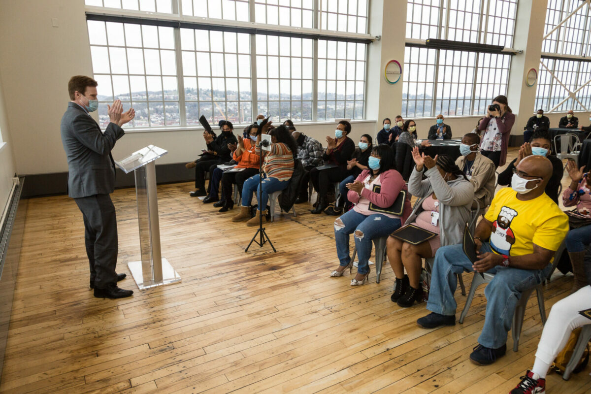 Val Alksnis, senior director of Environmental Services for UPMC, congratulates graduates of a recent environmental service technician training program during a ceremony at Energy Innovation Center in Pittsburgh, where the classes take place. This program is available to participants of the Pathways to Work program, a workforce development initiative of the UPMC Center for Social Impact.