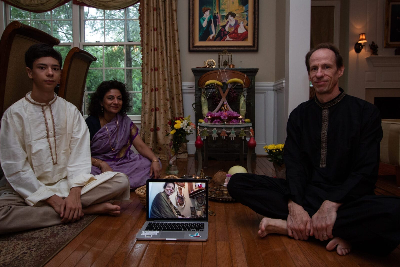Nikhil Walling, 16, his parents, Smitha and John Walling, and his grandmother, Shantha Rao (on FaceTime) pose for a family portrait at their home in Wayne, PA on August 23, 2020. Every fall, the family celebrates the Hindu festival honoring Ganesha, the elephant-headed god of wisdom. Their religious practice includes special foods and rituals led by Rao, the spiritual matriarch of the family. Due to health concerns amid the coronavirus pandemic, Rao, who is 75, has been unable to travel from her home in Richland, Washington. This year, they adapted the tradition to include virtual mantras in addition to in-person prayers. (Photograph by Melina Walling)