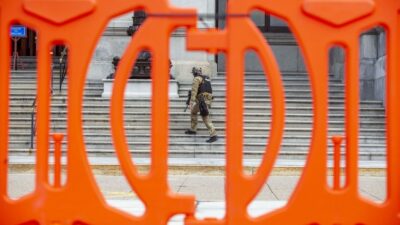 Law enforcement has erected orange fencing and deployed armed officers outside the Pennsylvania State Capitol. (Mark Pynes / PennLive)
