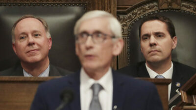 In this Jan. 22, 2020, file photo, Wisconsin Assembly Speaker Robin Vos, R-Rochester, left, and Wisconsin Senate President Roger Roth, R-Appleton, right, look on as Gov. Tony Evers delivers his State of the State address at the Wisconsin state Capitol in Madison, Wis. Gov. Evers signed a bipartisan tax cut bill into law on Feb. 18, 2021, and signaled support for another bipartisan measure to help update the state's unemployment insurance system, rare compromises that come as Republicans have roundly denounced much of his state budget proposal as a liberal wish list. (Amber Arnold/Wisconsin State Journal via AP, File)