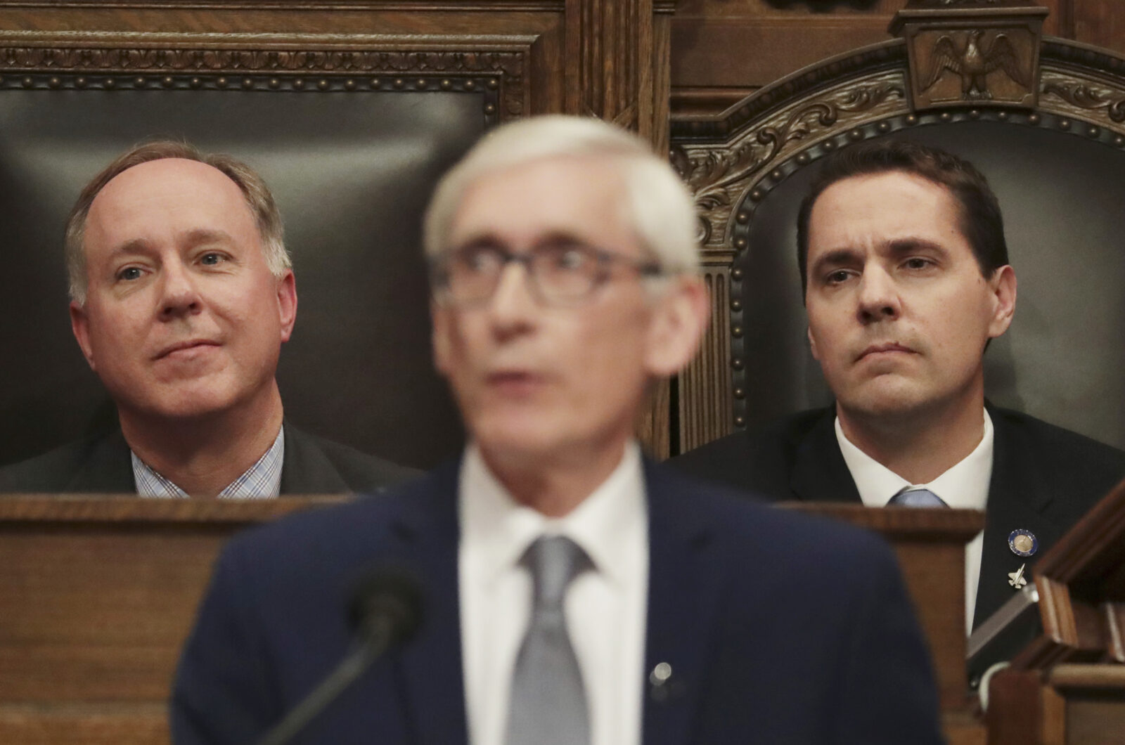 In this Jan. 22, 2020, file photo, Wisconsin Assembly Speaker Robin Vos, R-Rochester, left, and Wisconsin Senate President Roger Roth, R-Appleton, right, look on as Gov. Tony Evers delivers his State of the State address at the Wisconsin state Capitol in Madison, Wis. Gov. Evers signed a bipartisan tax cut bill into law on Feb. 18, 2021, and signaled support for another bipartisan measure to help update the state's unemployment insurance system, rare compromises that come as Republicans have roundly denounced much of his state budget proposal as a liberal wish list. (Amber Arnold/Wisconsin State Journal via AP, File)