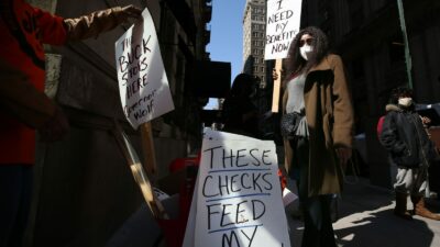 Michelle Perry of Philadelphia protested outside Gov. Tom Wolf's Center City office earlier this month, demanding "a working unemployment system to provide timely responses and benefits to unemployed workers." (DAVID MAIALETTI / Philadelphia Inquirer)