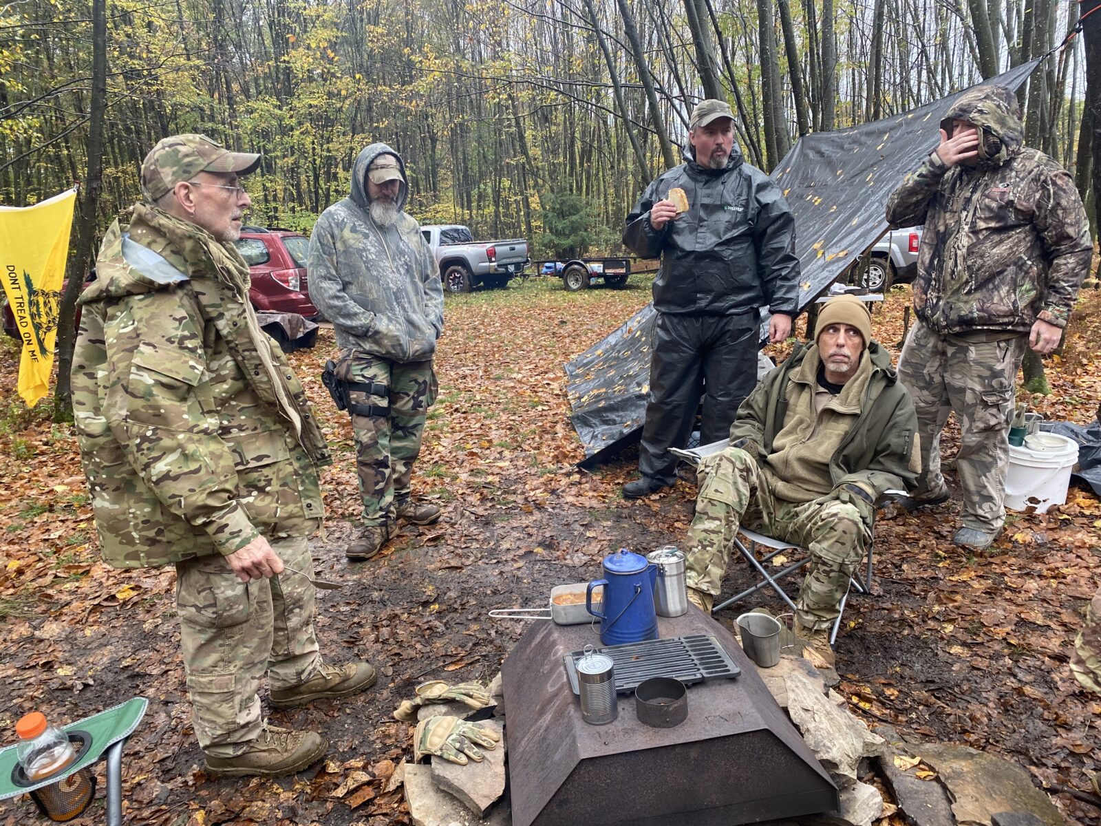 Pennsylvania Volunteer Militia members sit around a fire during a rainy militia training weekend. Militia groups have been increasingly active in recent years, showing up to protests, anti-lockdown rallies and even getting into electoral politics.