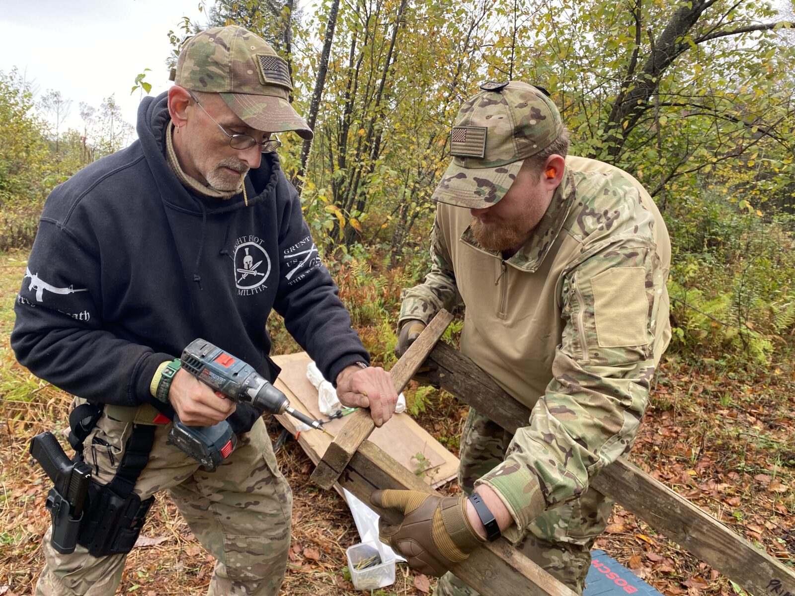 Members of the Pennsylvania Volunteer Militia build shooting targets for their monthly training deep in the woods. The group is led by Yingling, who played a role in the deadly Charlottesville, Va., "Unite the Right" rally in 2017 and was banned from returning to the city with a militia as a result of a lawsuit.
