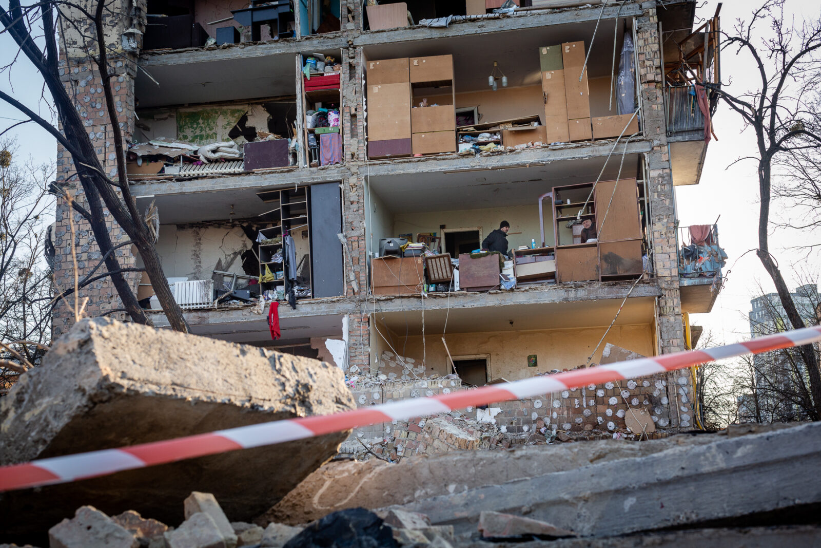 March 19: A Russian rocket attack destroyed apartments in the Vitryani Hory neighborhood of Kyiv, killing one man and injuring five, including children. Volunteers and residents work to clean up the aftermath.
