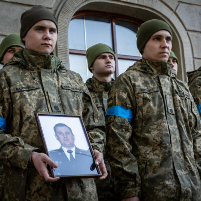 Ukrainian soldiers holding the photo of one of the 35 soldiers killed from the bombing of the International Peacekeeping and Security Center in Yavoriv outside of Lviv near the border with Poland Sunday morning. A funeral was held for three of those killed at the Church of the Most Holy Apostles Peter and Paul in Lviv, Ukraine.