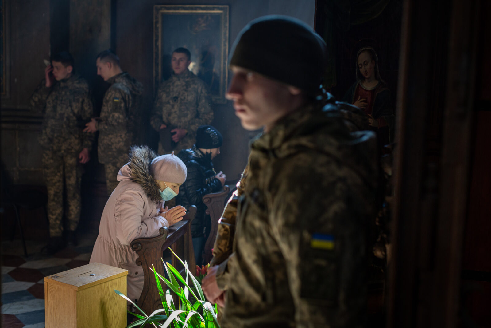 A funeral was held for three of those killed at the International Peacekeeping and Security Center in Yavoriv outside of Lviv near the border with Poland Sunday morning. It was held at the Church of the Most Holy Apostles Peter and Paul in Lviv, Ukraine. Women praying at the alter of the Virgin Mary during the funeral.