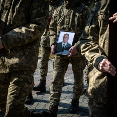 Ukrainian soldiers holding the photo of one of the 35 soldiers killed from the bombing of the International Peacekeeping and Security Center in Yavoriv outside of Lviv near the border with Poland Sunday morning. They were laid to rest at the Lychakiv Cemetery in Lviv, Ukraine.