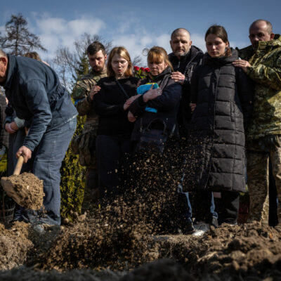 Relatives of one of the 35 soldiers killed from the bombing of the International Peacekeeping and Security Center in Yavoriv outside of Lviv near the border with Poland watch as their loved on is buried in the military section of the Lychakiv Cemetery in Lviv, Ukraine.