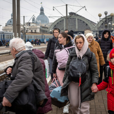 March 5: As the exodus from Ukraine intensifies, the Lviv railway station has become engulfed with people. Lviv is located about 50 miles from the Polish border. Here, families walk over the rail lines to get to the station.