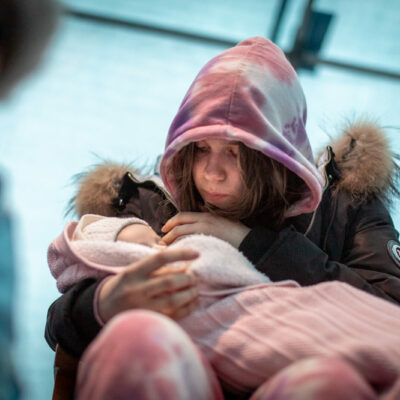 March 5: A woman cradles a baby in Lviv, amid a throng of people waiting to get out of the country.