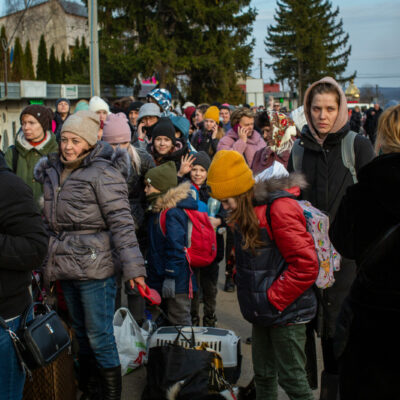 Ukrainian refugees waiting in a long line to cross into Medyka, Poland from Ukraine.