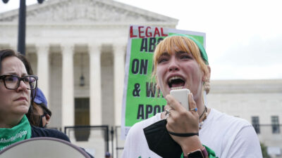 A tear rolls down an abortion-rights activist's cheek as they speak outside the Supreme Court in Washington, Friday, June 24, 2022. The Supreme Court has ended constitutional protections for abortion that had been in place nearly 50 years in a decision by its conservative majority to overturn Roe v. Wade. (AP Photo/Jacquelyn Martin)