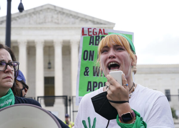 A tear rolls down an abortion-rights activist's cheek as they speak outside the Supreme Court in Washington, Friday, June 24, 2022. The Supreme Court has ended constitutional protections for abortion that had been in place nearly 50 years in a decision by its conservative majority to overturn Roe v. Wade. (AP Photo/Jacquelyn Martin)
