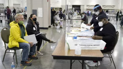 Election workers, right, verify ballots as recount observers, left, watch during a Milwaukee hand recount of presidential votes at the Wisconsin Center, Friday, Nov. 20, 2020, in Milwaukee. The recount of the presidential election in Wisconsin’s two most heavily Democratic counties began Friday with President Donald Trump’s campaign seeking to discard tens of thousands of absentee ballots that it alleged should not have been counted. (AP Photo/Nam Y. Huh)