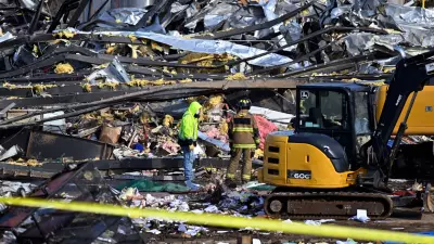 Emergency response workers dig through the rubble of the Mayfield Consumer Products candle factory in Mayfield, Ky., Saturday, Dec. 11, 2021. Tornadoes and severe weather caused catastrophic damage across multiple states late Friday, killing several people overnight. (AP Photo/Timothy D. Easley)