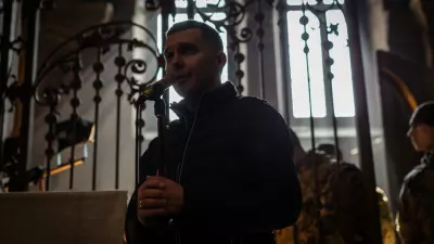 A funeral was held for three of those killed at the International Peacekeeping and Security Center in Yavoriv outside of Lviv near the border with Poland Sunday morning. It was held at the Church of the Most Holy Apostles Peter and Paul in Lviv, Ukraine. Clergy signing hymns.